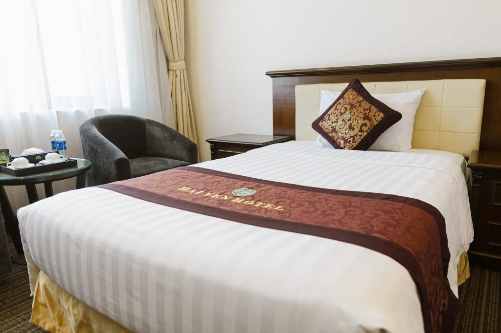 Giường phòng Classic với gối thêu logo Hải Yến